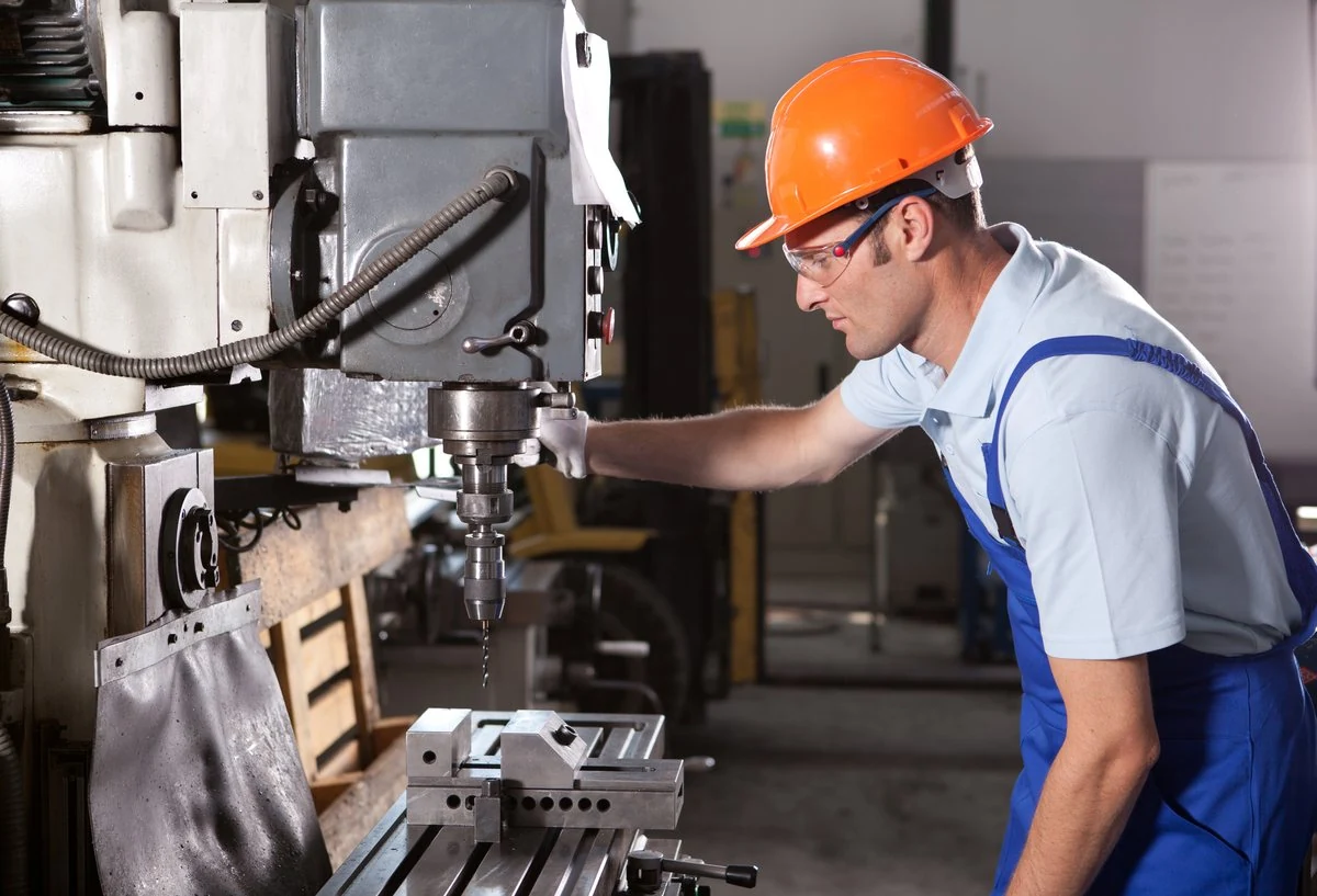 Operator working at a precision machining station